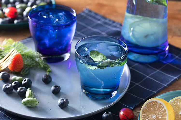 Blue glass tumblers and a glass carafe