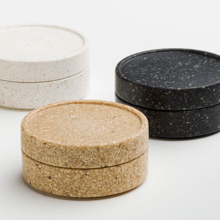 Three bioplastic containers in natural, cream and black tones