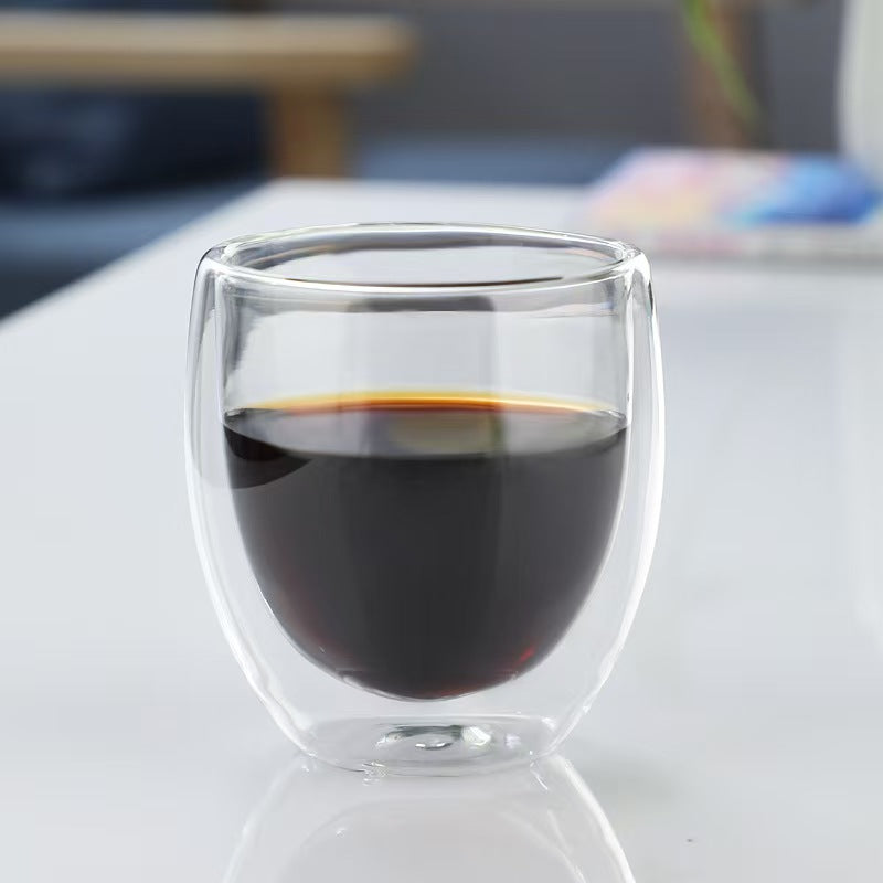 Double-wall borosilicate coffee glass filled with hot black coffee.