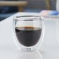 Double-wall borosilicate coffee glass filled with hot black coffee.