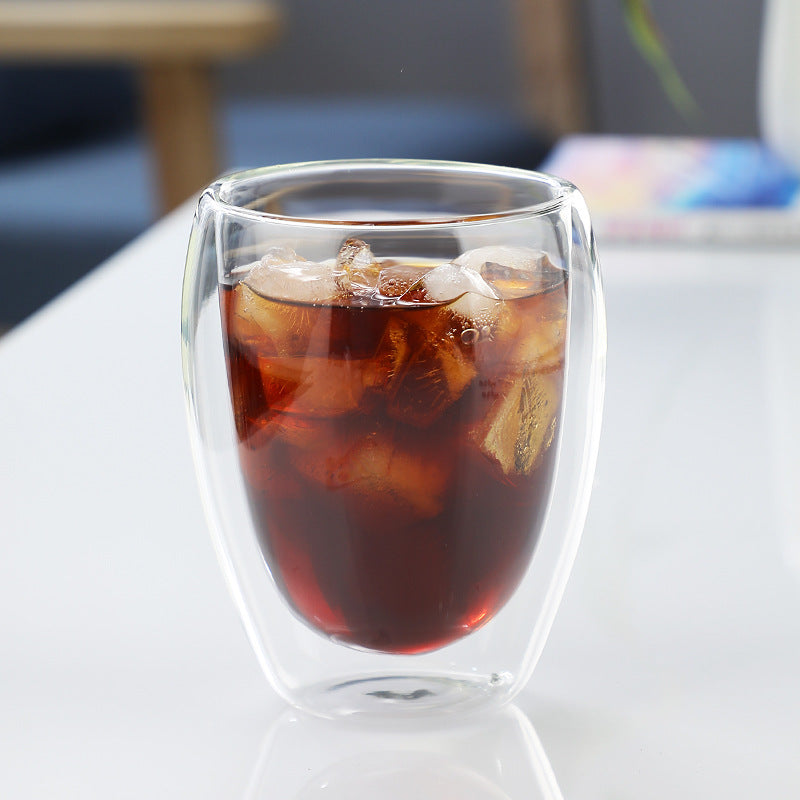 Double-wall borosilicate coffee glass filled with iced coffee.