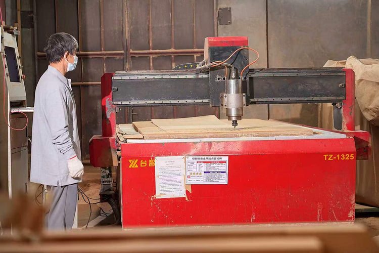 Worker operating a wood cutting machine