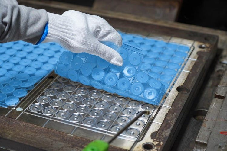 Blue silicone components being released from a metal mold